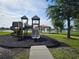 Community playground area with lake views and shaded seating at 4901 Stone Acres Cir, St Cloud, FL 34771