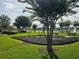 Community playground with swings and splash pad area overlooks a picturesque pond at 4901 Stone Acres Cir, St Cloud, FL 34771