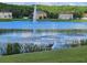 Beautiful view of the pond with a fountain and greenery at 4901 Stone Acres Cir, St Cloud, FL 34771
