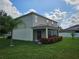 Exterior of home, with a screened patio, beige siding, and flower bed at 4901 Stone Acres Cir, St Cloud, FL 34771