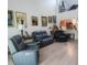 Living room featuring high ceilings, laminate floors, and modern furniture and decor at 525 Oak Ter # 117, Altamonte Springs, FL 32701