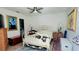 Bright main bedroom with a white iron bed frame, hardwood floors, and neutral decor at 525 Oak Ter # 117, Altamonte Springs, FL 32701