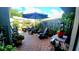 Outdoor patio featuring brick flooring, an umbrella, chairs, and various potted plants at 525 Oak Ter # 117, Altamonte Springs, FL 32701