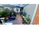 Outdoor patio featuring brick flooring, a privacy fence, chairs, and various potted plants at 525 Oak Ter # 117, Altamonte Springs, FL 32701