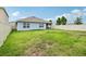 Spacious backyard with lush green grass and a white fence, offering a private outdoor space at 585 Talisi Loop, St Cloud, FL 34771