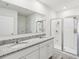 Clean bathroom with double sink vanity, granite countertop, and glass-enclosed shower at 585 Talisi Loop, St Cloud, FL 34771