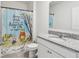 Well-lit bathroom with a vanity and a Winnie the Pooh shower curtain at 585 Talisi Loop, St Cloud, FL 34771