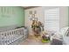 Cozy Bedroom with soft colors, a crib, and a tree-shaped bookshelf at 585 Talisi Loop, St Cloud, FL 34771