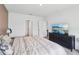 Well-lit bedroom showcases neutral walls, and carpet, with a TV mounted on the dresser at 585 Talisi Loop, St Cloud, FL 34771