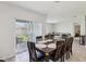 Bright dining area with a large wooden table, seating for eight, and sliding doors to the backyard at 585 Talisi Loop, St Cloud, FL 34771