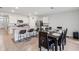 Open-concept kitchen with granite countertops, a breakfast bar, stainless appliances, and dining area at 585 Talisi Loop, St Cloud, FL 34771