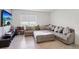 Cozy living room features a large sectional sofa, tile floors, and a wall-mounted television at 585 Talisi Loop, St Cloud, FL 34771