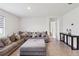 Bright and airy living room with tile flooring, a large sectional sofa, and a neutral color palette at 585 Talisi Loop, St Cloud, FL 34771