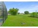 Spacious backyard with grass and foliage is perfect for relaxation and recreation at 605 Elbridge Dr, Kissimmee, FL 34758