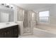 Bright bathroom features a bathtub and shower combo and modern vanity at 605 Elbridge Dr, Kissimmee, FL 34758