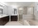 Bright bathroom features double vanity, glass shower, and separate soaking tub at 605 Elbridge Dr, Kissimmee, FL 34758