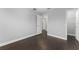 The bright bedroom includes dark hardwood floors, closet space, and access to more rooms at 605 Elbridge Dr, Kissimmee, FL 34758