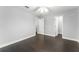 This is a clean and bright bedroom featuring hardwood floors and an open closet at 605 Elbridge Dr, Kissimmee, FL 34758