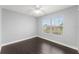 Bedroom features hardwood floors, a ceiling fan and a window with natural light at 605 Elbridge Dr, Kissimmee, FL 34758
