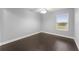 Bedroom featuring hardwood floors, base trim and a window with natural light at 605 Elbridge Dr, Kissimmee, FL 34758
