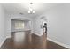 Open dining space with hardwood floors, chandelier, and flow into the kitchen area at 605 Elbridge Dr, Kissimmee, FL 34758