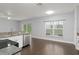 Modern kitchen featuring stainless steel appliances, white cabinets, and hardwood flooring at 605 Elbridge Dr, Kissimmee, FL 34758