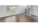 Bright living room featuring sleek hardwood floors, a staircase, and ample natural light at 605 Elbridge Dr, Kissimmee, FL 34758