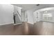 Spacious living area featuring hardwood floors, a staircase, and arched openings at 605 Elbridge Dr, Kissimmee, FL 34758