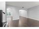 Open-concept living area with hardwood floors, arched doorways, and neutral gray walls at 605 Elbridge Dr, Kissimmee, FL 34758