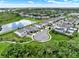 Aerial view of a residential community featuring lush landscaping and a pond at 6905 Cucamelon Ct, Windermere, FL 34786