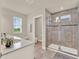 Elegant bathroom with a modern glass shower, spacious vanity, and natural light at 6905 Cucamelon Ct, Windermere, FL 34786