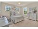Serene bedroom featuring a queen bed with decorative pillows, dresser, and soft natural light at 6905 Cucamelon Ct, Windermere, FL 34786