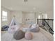 Bright bonus room with plush seating, a play tent, and neutral decor creating a fun and inviting space at 6905 Cucamelon Ct, Windermere, FL 34786
