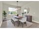 Bright dining room features modern chandelier, large window, and stylish decor at 6905 Cucamelon Ct, Windermere, FL 34786