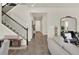 Inviting entryway with hardwood floors, staircase and a decorative mirror reflecting the living space at 6905 Cucamelon Ct, Windermere, FL 34786