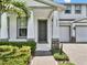 Charming home featuring a covered front porch, manicured landscaping, and an attached two-car garage at 6905 Cucamelon Ct, Windermere, FL 34786