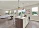 Stylish kitchen with an island, a dining table, and a seamless transition to outdoor spaces at 6905 Cucamelon Ct, Windermere, FL 34786