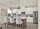Well-lit kitchen featuring stainless steel appliances, a center island with seating, and ample cabinetry at 6905 Cucamelon Ct, Windermere, FL 34786