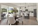 Bright kitchen and dining area with modern appliances, a large island, and sliding glass doors at 6905 Cucamelon Ct, Windermere, FL 34786