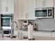 Modern kitchen with stainless steel appliances and white cabinets, perfect for cooking at 6905 Cucamelon Ct, Windermere, FL 34786