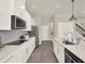 Modern kitchen with stainless steel appliances, white cabinets, a spacious counter, and open layout at 6905 Cucamelon Ct, Windermere, FL 34786