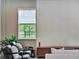 Relaxing living room with decorative wall, chairs, and entertainment center at 6905 Cucamelon Ct, Windermere, FL 34786