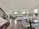 Spacious living room with wood floors, a large sofa, and an adjacent dining area at 6905 Cucamelon Ct, Windermere, FL 34786
