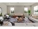 Inviting living room with modern furniture, a stylish rug, and lots of natural light at 6905 Cucamelon Ct, Windermere, FL 34786