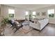Comfortable living room featuring modern decor, large windows, and a cozy seating arrangement at 6905 Cucamelon Ct, Windermere, FL 34786