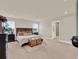 Spacious main bedroom featuring a luxurious bed, stylish decor, and large windows at 6905 Cucamelon Ct, Windermere, FL 34786
