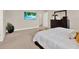 Comfortable main bedroom with a TV, soft carpet and tasteful decor at 6905 Cucamelon Ct, Windermere, FL 34786