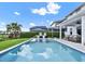 Beautiful backyard oasis with a sparkling pool, patio seating, lush landscaping, and mature trees at 6905 Cucamelon Ct, Windermere, FL 34786