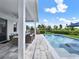 Inviting pool area with lounge chairs, umbrella, and outdoor seating overlooking a serene backyard view at 6905 Cucamelon Ct, Windermere, FL 34786