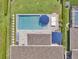 Aerial close up of a refreshing pool with umbrellas and lounge chairs at 6905 Cucamelon Ct, Windermere, FL 34786